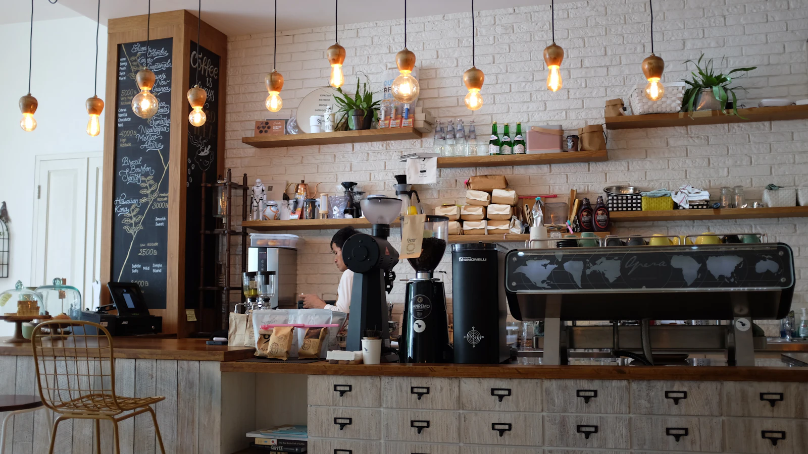 Coffee bar with hanging lights and an espresso machine